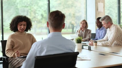 Wall Mural - Attractive woman engages in conversation with a man during job interview.