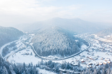 Wall Mural - mountain valley. scene from drone. forest covered in snow. natural winter landscape from air. landsc