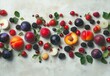 © ANUAR - Vibrant Arrangement of Fresh Fruits Including Peaches, Plums, Berries, and Apples on a Soft Textured Background for Culinary and Wellness Themes