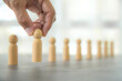 © Jintana - Hand choose wooden person for HR human resources or personal leader training skill or leadership and challenge business team player and organization management teamwork.