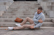 © New Africa - Man with injured arm on stairs outdoors after fall. Dangerous accident