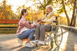 © New Africa - Caregiver with elderly woman in wheelchair at park