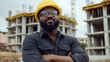 © Benjamin - Black male civil engineer in uniform smiling on construction site.