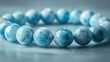 © godex - Serene Sky Blue Larimar Bracelet: A close-up shot showcasing the exquisite beauty of a Larimar gemstone bracelet.  The smooth, polished beads capture the light.