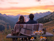 © PixelMinds - A couple shares a cozy moment during a scenic mountain sunset.