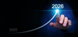 © OleCNX - Happy new year. A businessman draws a line rising up, from 2025 to  2026, representing aimed growth, achievement, and success,to start and welcome the new coming year.