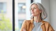 © Napak - Contemplative senior woman gazing out window