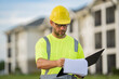 © Volodymyr - Builder on site construction. Engineer with clipboard, building inspection. Man worker in hard hat. Construction worker in helmet at construction new home building.
