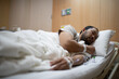 © SAHARAT - A man resting alone in a hospital room, receiving IV Fluids and Medical Care