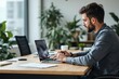 © ThomasLENNE - Entrepreneur working with a laptop at office