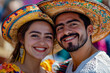 © stanhert - A man and a woman wearing sombreros smile at the camera
