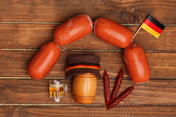 glass of beer and sausage and german hat. Concept of symbols of different countries