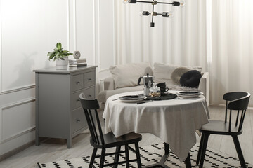 Wall Mural - Stylish table setting with beautiful dishware and black chairs in dining room