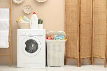 Wall Mural - Wicker basket full of laundry, washing machine and detergent in bathroom