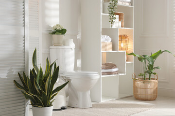 Wall Mural - Folding screen, toilet bowl and houseplants in restroom