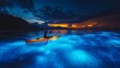 © Christiankhs - A lone kayaker paddling through a vibrant bioluminescent bay at night, water glowing blue