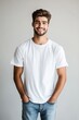 © evgenia_lo - Male model wearing a white t-shirt and jeans smiles confidently with hands in pockets