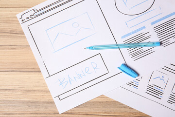 Wall Mural - website development. sketches of wireframes and pen on wooden table, flat lay