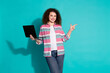 © deagreez - Photo of worker young successful woman curly hair brunette in striped shirt hold netbook introuce her presentation isolated on cyan color background