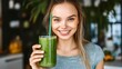 © Professional Agency - Young woman smiling and holding a green smoothie