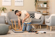 © Pixel-Shot - Young man assembling bench at home
