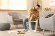 © Pixel-Shot - Young man with screwdriver assembling small table at home