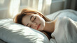 © 沈军 贡 - Beautiful young woman sleeping in bed, a happy girl resting with eyes closed on a white pillow in a home or hotel room