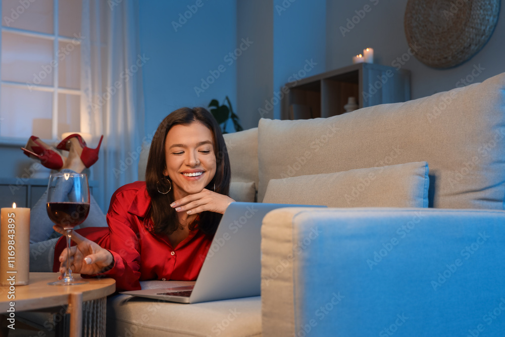 Young woman having online date on sofa at home in evening
