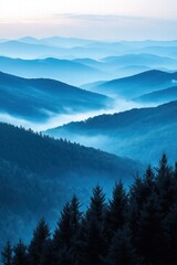 majestic blue mountain landscape with mist in dawn light revealing layers of hills