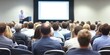 © Planetz - Large group of diverse individuals sitting in chairs attentively watching a presentation in a modern conference setting