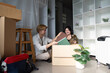 © Natee Meepian - Family couple joyfully moving house together modern apartment lifestyle indoor warm vibe