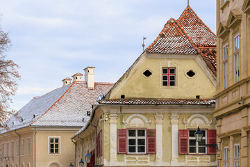 Wall Mural - A row of buildings with a yellow house in the middle