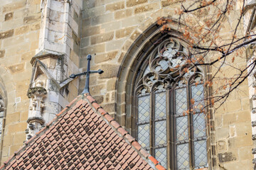 Wall Mural - A building with a cross on top and a window with a lattice design