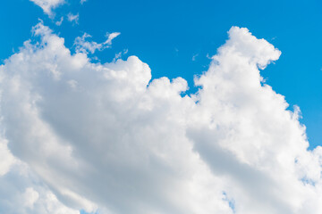 Wall Mural - Blue sky with clouds in the sky. Sky clouds background. White cloudy Heaven with soft sun light. Clouds on pastel blue sky background.