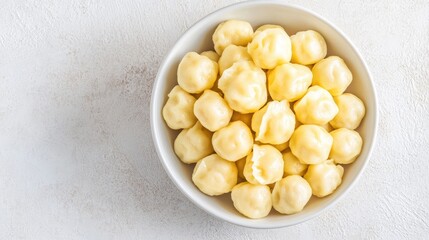 Poster - A bowl of traditional dumplings arranged neatly, symbolizing family unity, on a light-colored table with space.