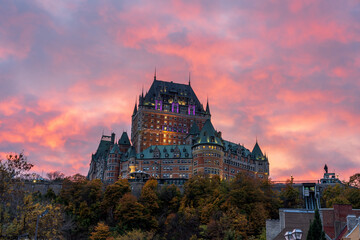 Wall Mural - Quebec City Old Town street view in autumn sunset time, stunning red pink clouds over the sky in dusk. Text in French is 