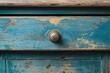 © Oleg - A blue wooden cabinet door with distressed paint, peeling off in places to reveal underlying layers. Old-fashioned design suitable for vintage or rustic interior decor.