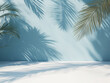 © Dwiyan - minimalist concept with palm leaves casting shadows on a blue wall and pastel floor, creating a summer tropical beach background in an empty room ideal for product placement