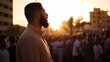 © trustmastertx - Man with beard speaks to crowd at sunset.