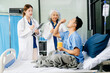 © Nuttapong punna - Hospital Ward Male and  Male Professional Asian Doctors Talk with a Patient, Give Health Care Advice