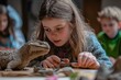 © Luxetify - Girl examining dinosaur model, classroom, paleontology lesson