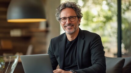 Aufkleber - Middle-aged professional man working on laptop in modern office environment with natural light and relaxing decor