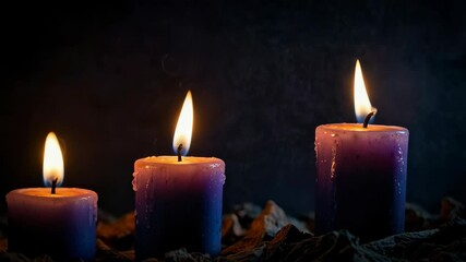 Wall Mural - An atmospheric background with a group of lit candles in the dark