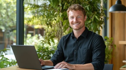 Aufkleber - Relaxed man with auburn hair smiles while working on laptop in a stylish indoor space