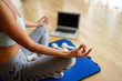 © NDABCREATIVITY - Happy fit sporty woman exercising to stay healthy. Fitness workout at home, watching videos online