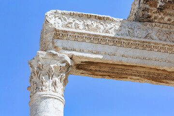 Wall Mural - Close-up of a column capital and entablature fragment with ornate carvings from Laodicea, set against a vibrant blue sky. Denizli, Turkey (Turliye)