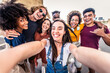 © Davide Angelini - Happy diverse young people taking selfie photo with smart mobile phone outside - Cheerful friends smiling at camera together - People and youth community concept