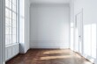 © grey - A white room with a brown wooden floor, white walls, and a window on the left side.