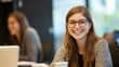 © Julia - Happy female business professional with colleagues in meeting at office