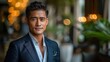 © Ghulam - A confident young Asian businessman dressed professionally for an office setting, highlighting his success and self-assurance